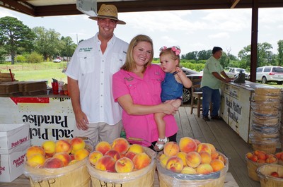 Mark and Shay Morgan and Kate at peach stand